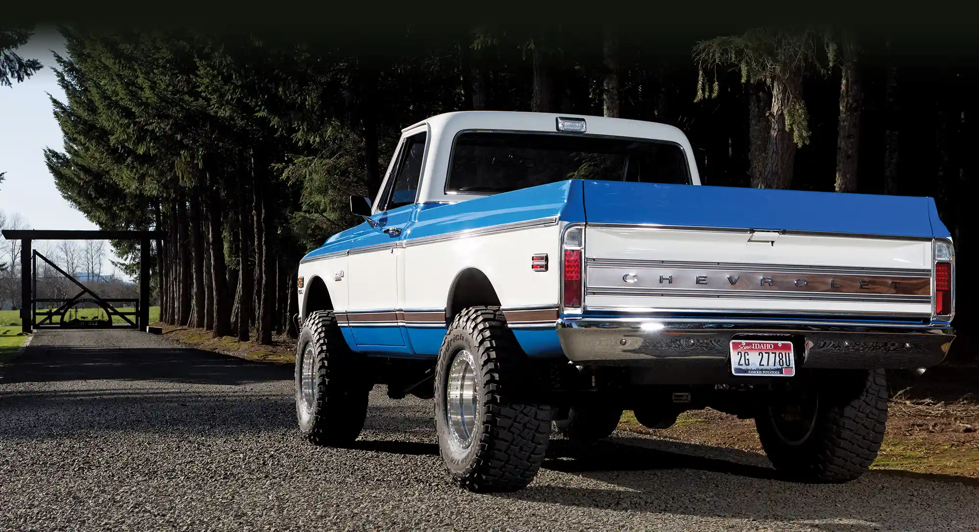 Front view of 1972 Chevy K10 showcasing classic chrome grille, dual headlights, and vibrant blue-and-white color scheme