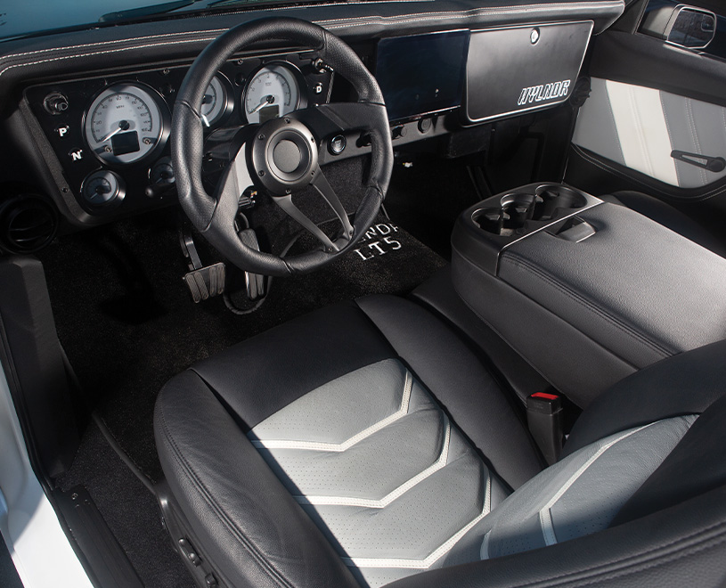 interior of 1969 Chevrolet C10 featuring custom leather seats with white accents and a modernized dashboard