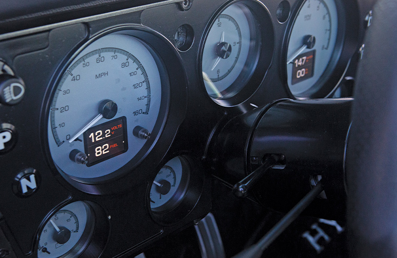close-up of modern gauges in a 1969 Chevrolet C10, showcasing integrated digital displays