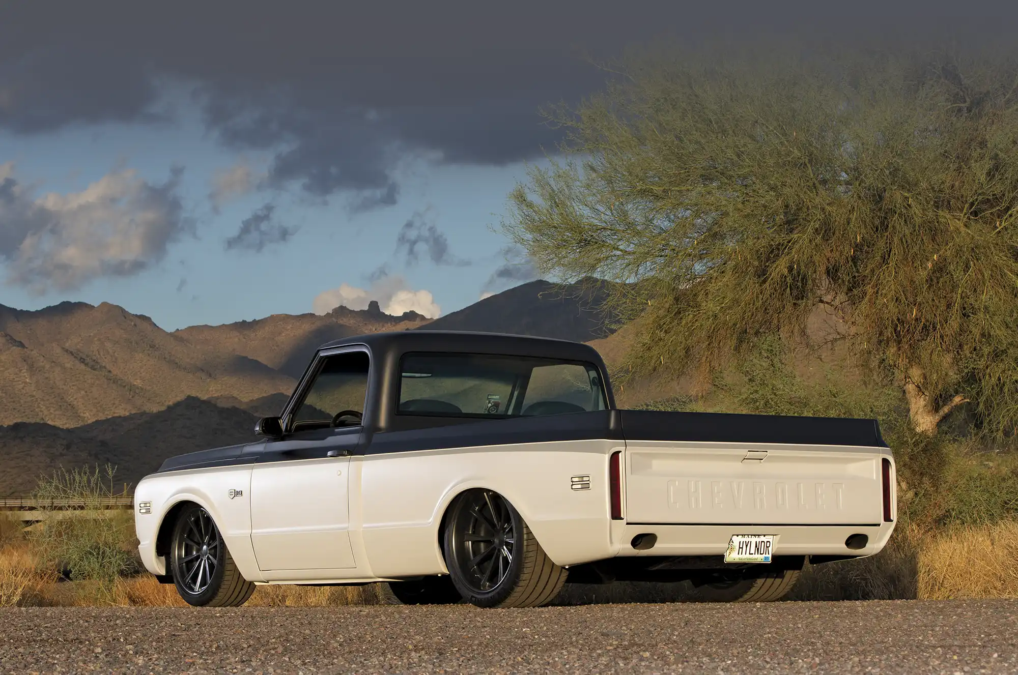 rear quarter angle of 1969 Chevrolet C10, showcasing dual exhausts and custom tailgate lettering