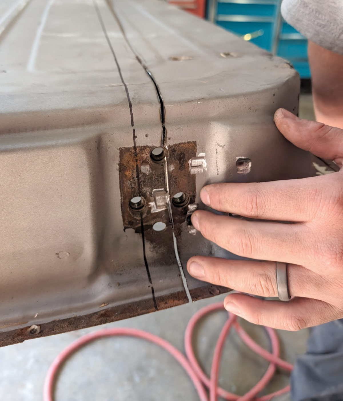 Technician aligning cuts on 1966 Chevy truck door panel for seamless repair