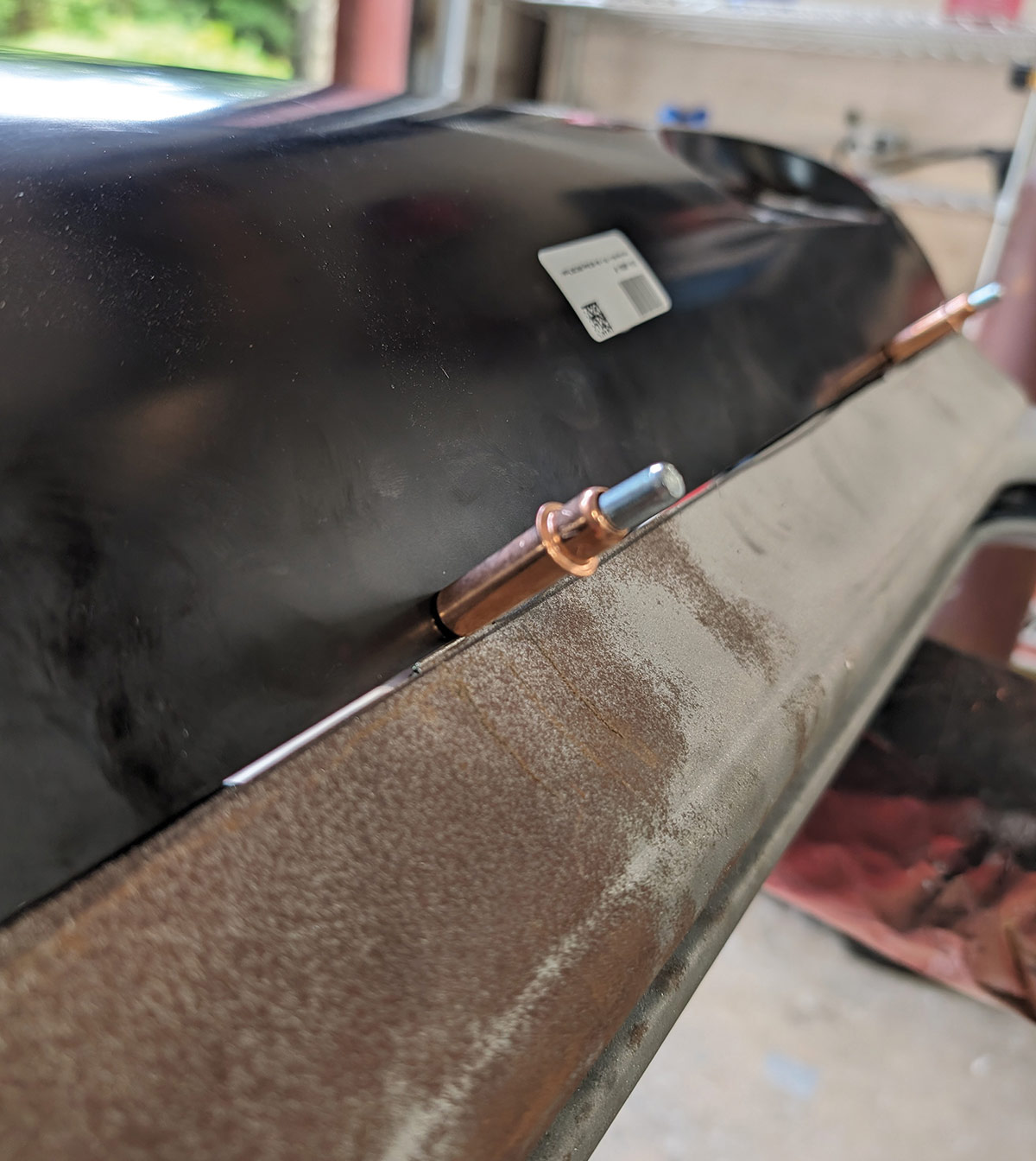 Cleco fasteners securing black replacement panel on 1966 Chevy truck door