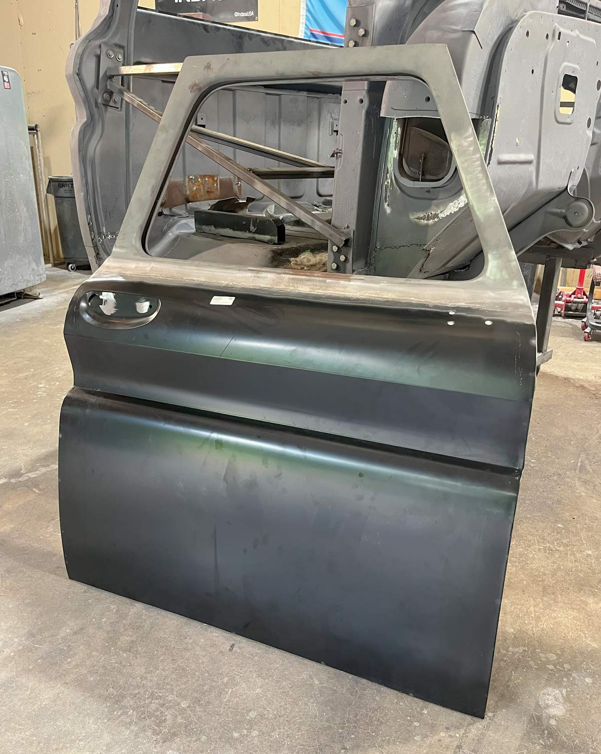 Fully assembled black-skinned 1966 Chevy truck door ready for installation