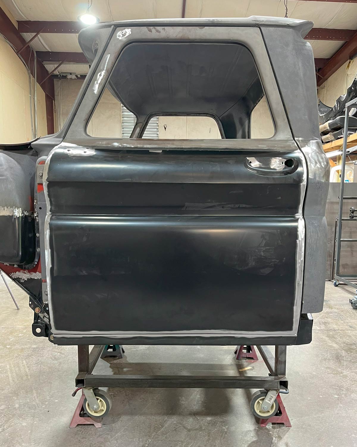 Completed 1966 Chevy truck door fitted on the cab showing aligned bodywork