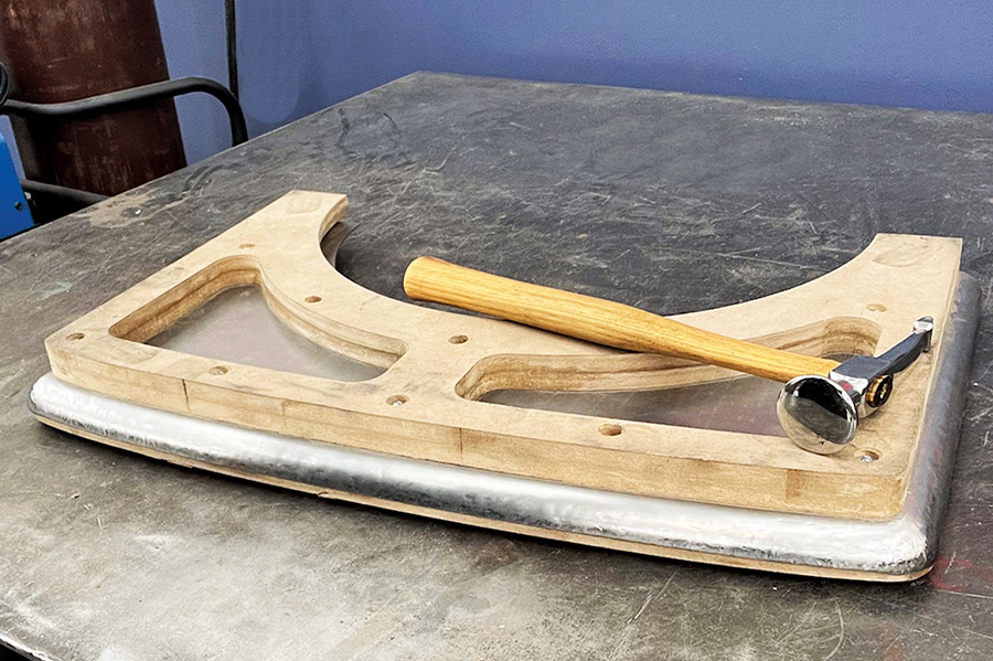 Wood forming buck hammer shaping custom steel panel fabrication curved edge design metalworking