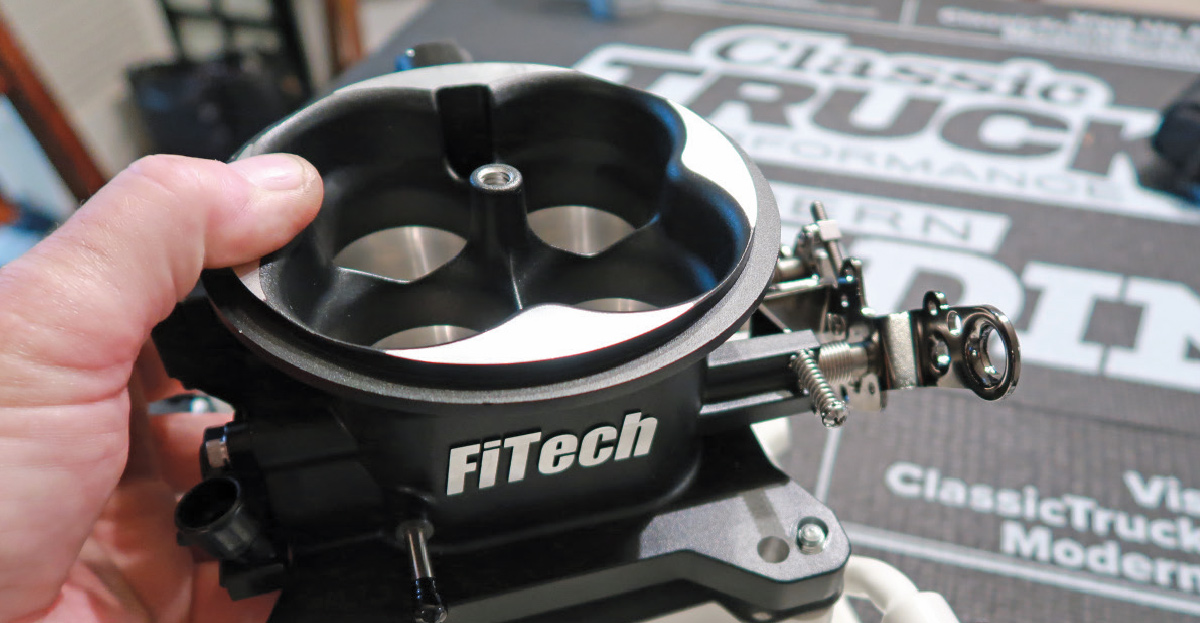 FiTech four-barrel throttle body mounted on the intake manifold for precise electronic fuel injection control