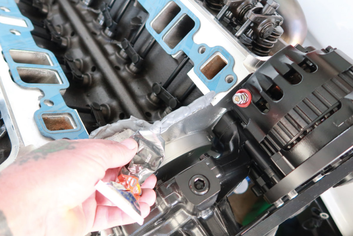 Sealing the intake ports with gaskets on a small-block Chevy engine to prepare for manifold installation