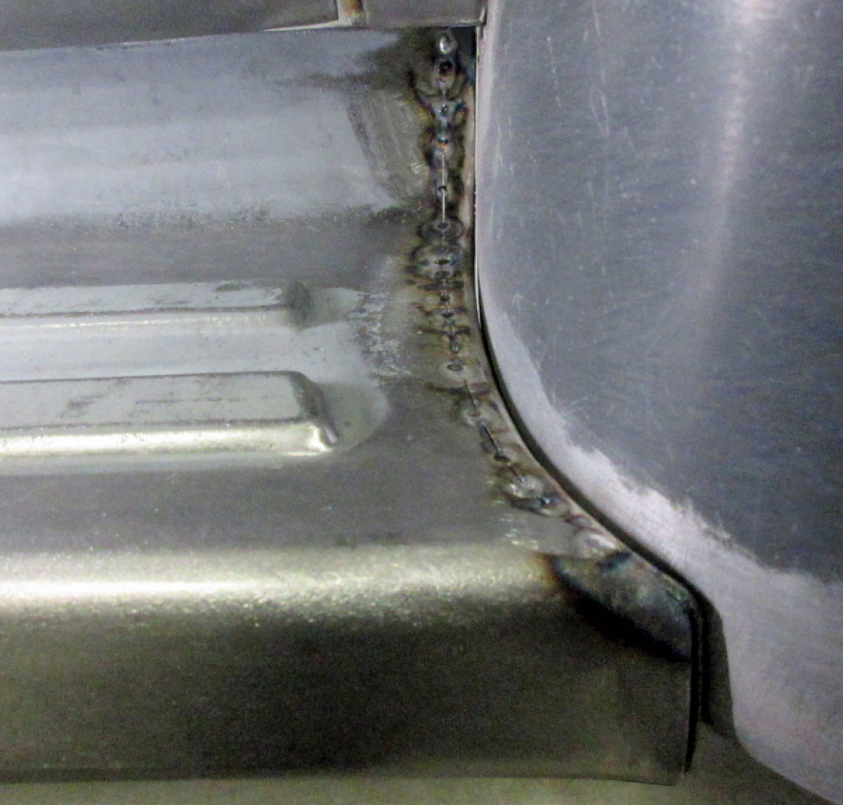 Ford F100 cab corner weld seam close-up view