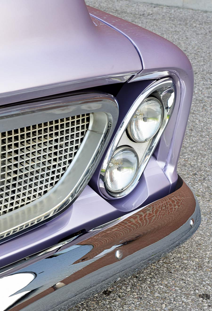 1956 Ford F100 close-up of dual headlights with chrome accents and a curved front bumper