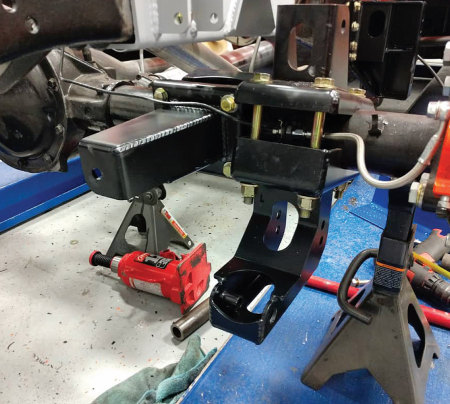 closeup of Detroit Speed suspension and axle mounts fitted on C10 chassis for rear-end upgrade