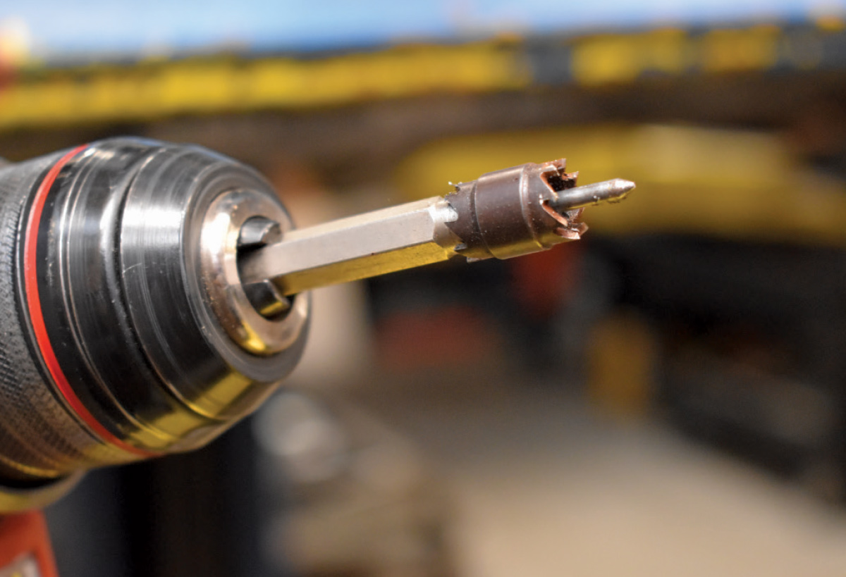 Hole saw bit attached to a drill for removing old spot welds