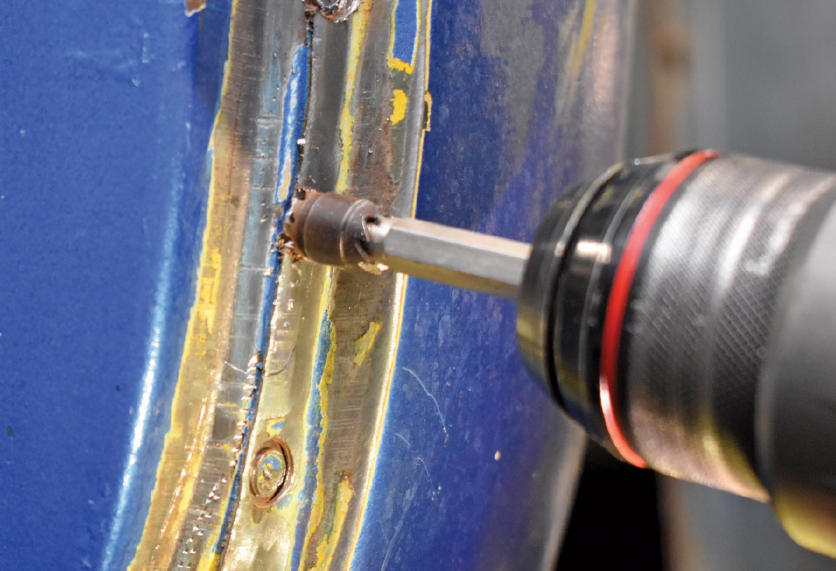 Drilling out factory spot welds to remove the rusted panel