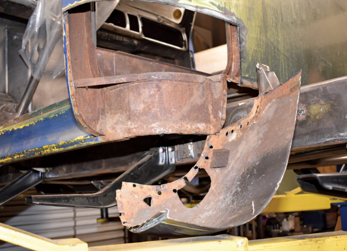 A heavily rusted cab corner removed from the truck, exposing internal structure