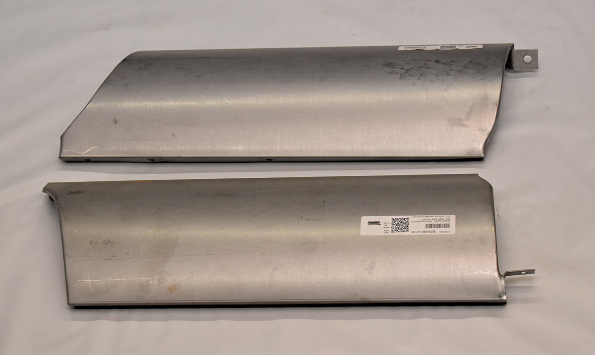 Pair of stamped steel rocker panel repair sections ready for installation
