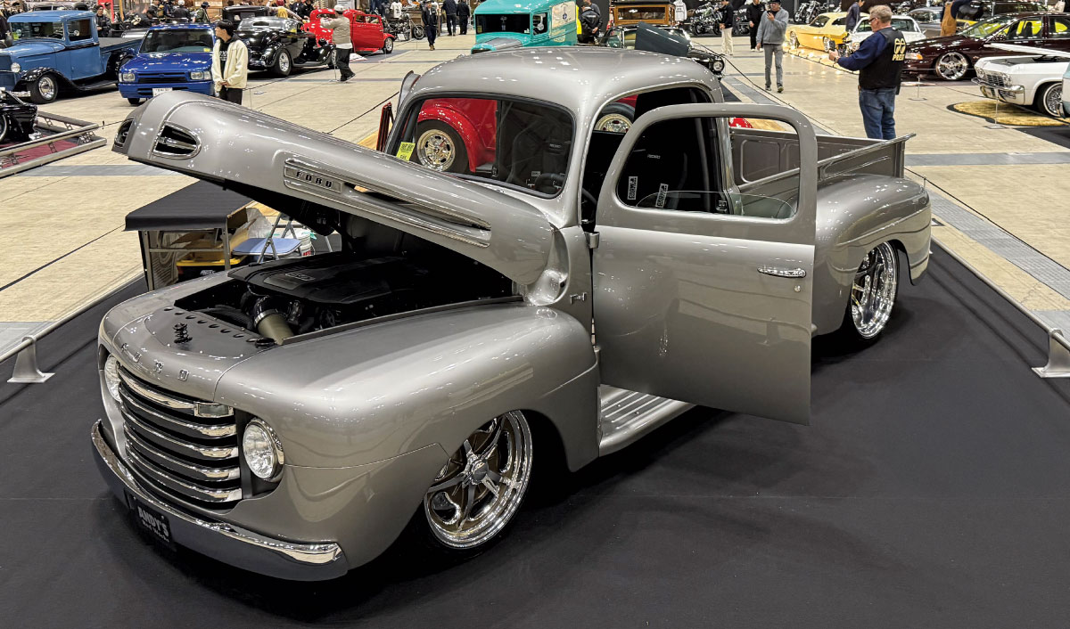 1949 Ford F1 – Silver with a modern stance, polished wheels, and a custom engine bay on display