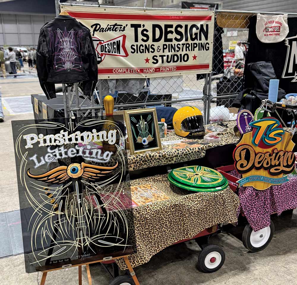 Pinstriping booth – T’s Design showcasing hand-painted pinstriping and custom artwork