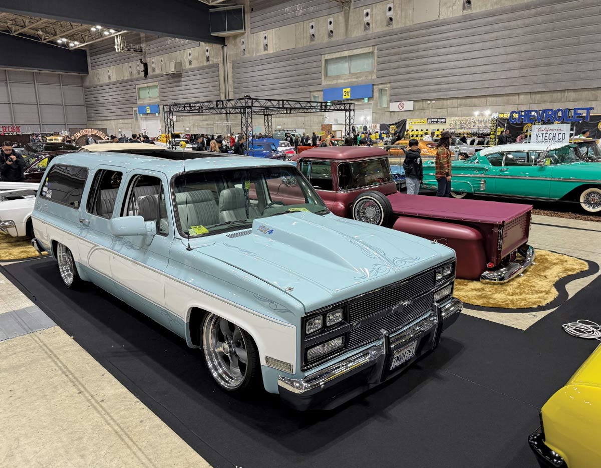 1980s Chevy Suburban – Two-tone baby blue, slammed on billet wheels, with a cowl hood