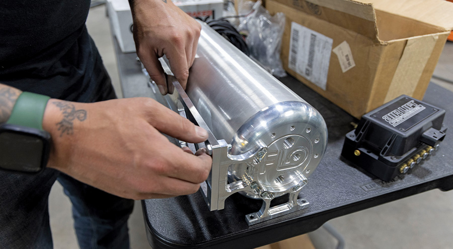 Custom mounting bracket being installed on the air tank