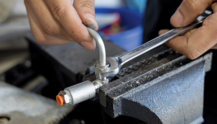 Stainless air line being secured with a wrench for a tight seal