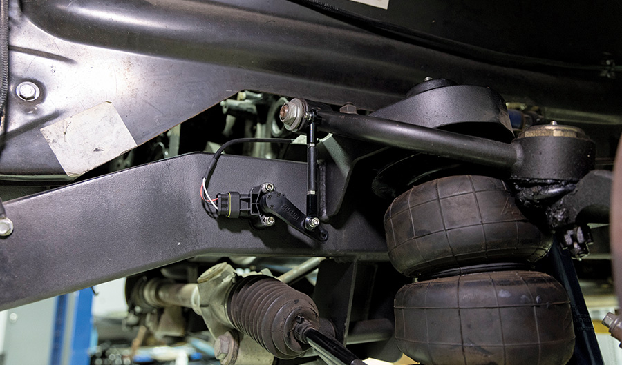 Installed ride height sensor linked to the suspension arm