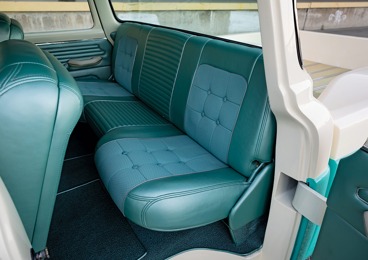 1960 Ford F-100 rear seating area with custom teal upholstery and modern stitching