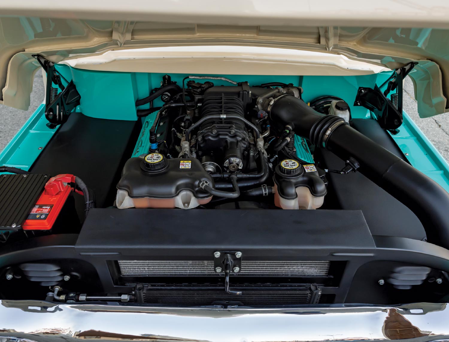 1960 Ford F-100 engine bay featuring a modern supercharged powerplant