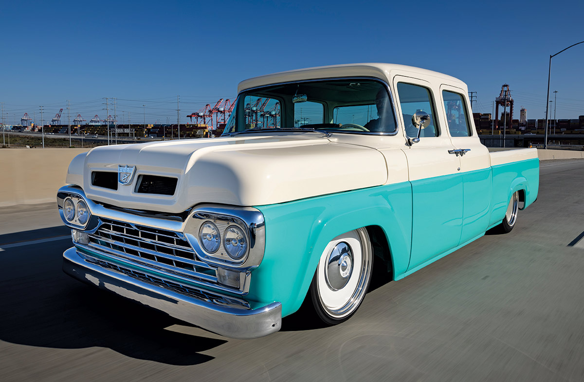 1960 Ford F-100 rolling down the highway with a classic stance and chrome grille