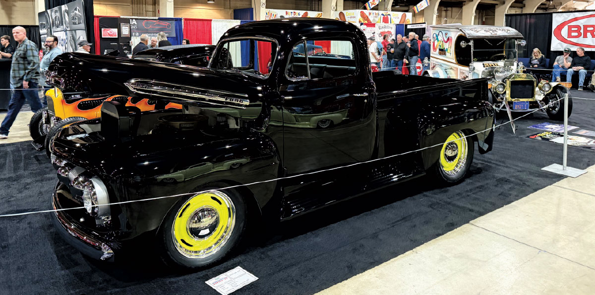 black truck with flame detailing parked with hood open