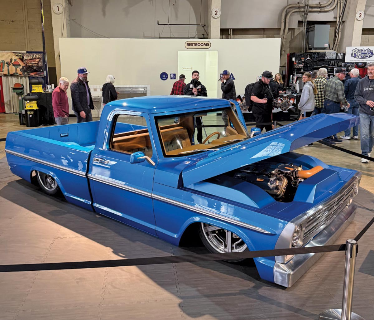 side view of blue truck with hood open