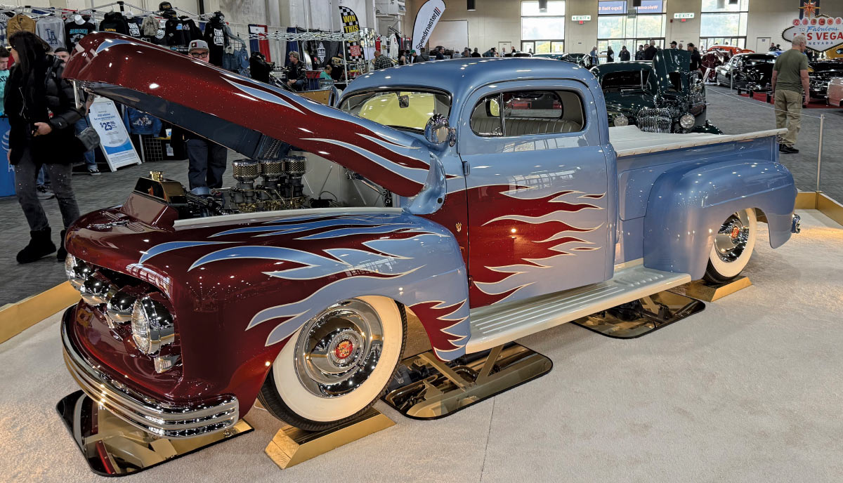 side view of light blue truck with red flame detailing