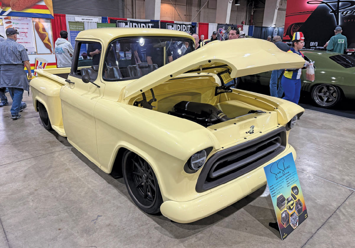 front view of yellow truck with hood popped open