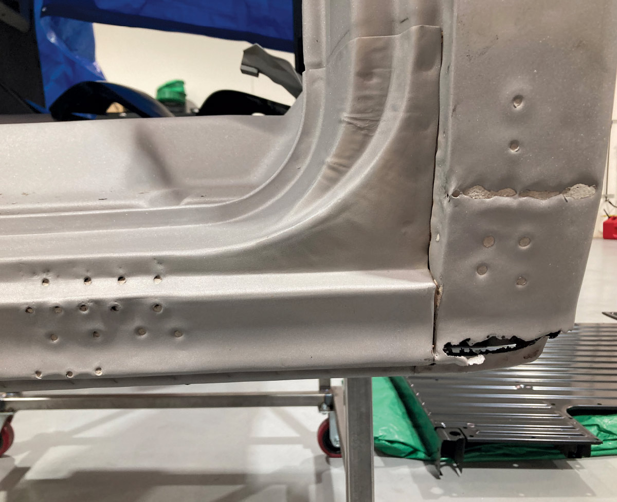 Inner rocker panel showing rust holes and previous spot weld locations