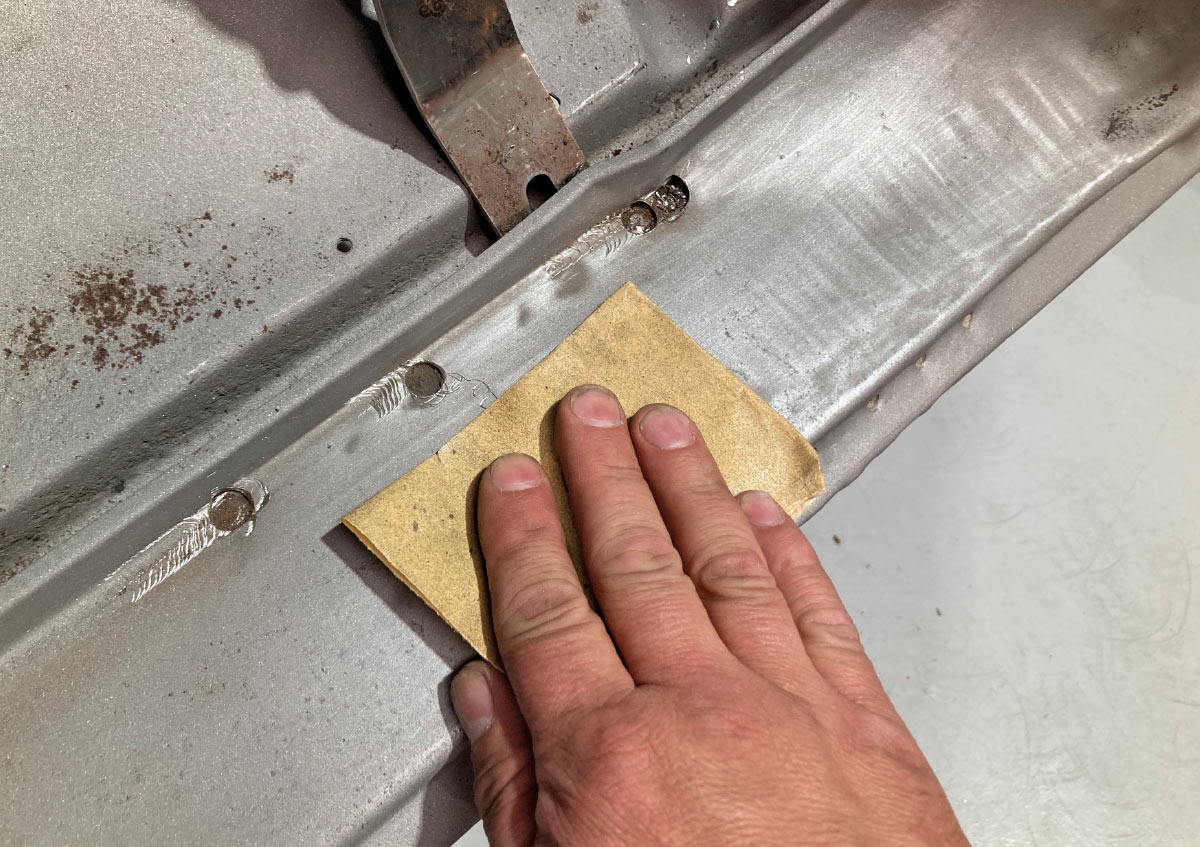 Sanding down welds for a smooth surface before new panel installation