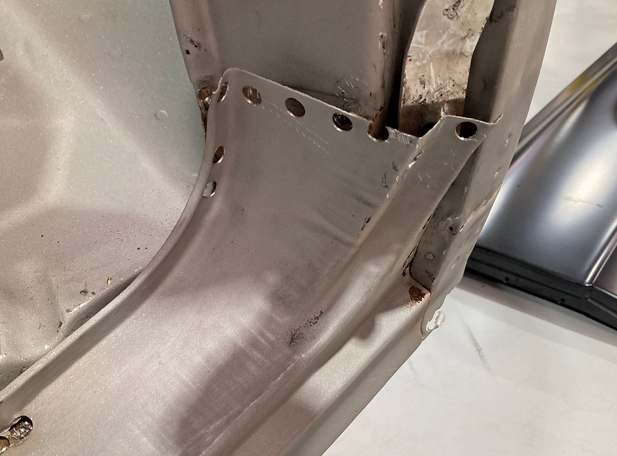 Rusted-out rocker panel section removed for repair and replacement