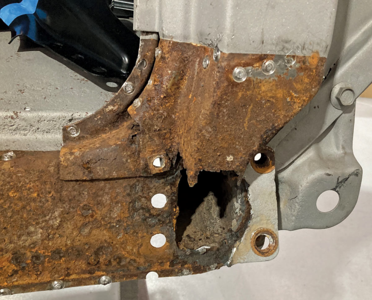Drilled-out spot welds preparing for removal of rusted-out metal
