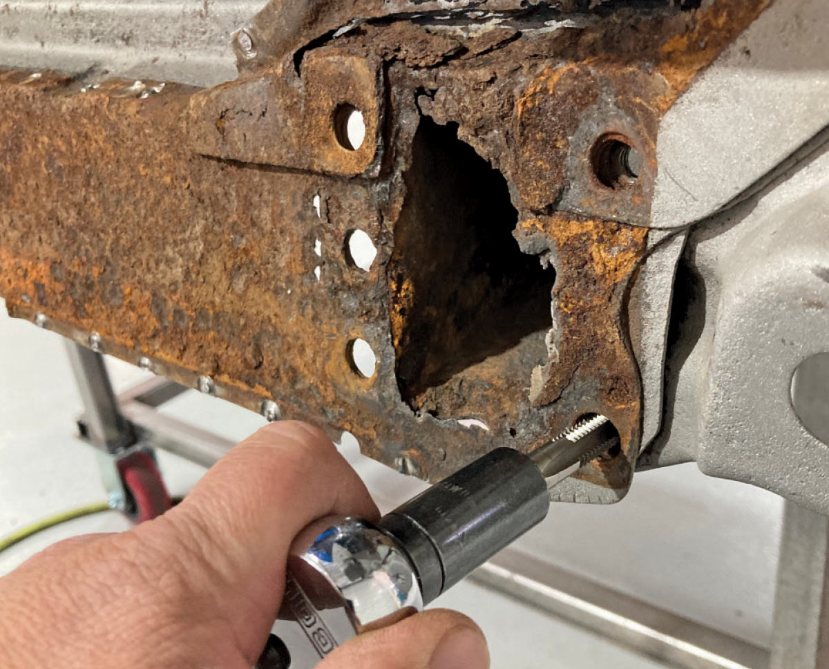 Tapping threads into a mounting hole for the new panel installation