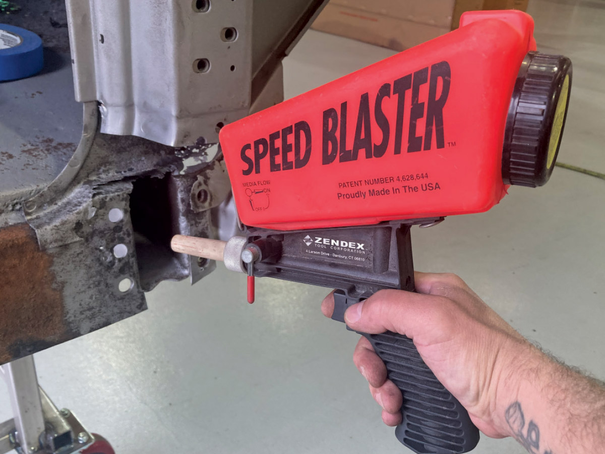 Sandblasting rusted metal to clean and prepare for welding