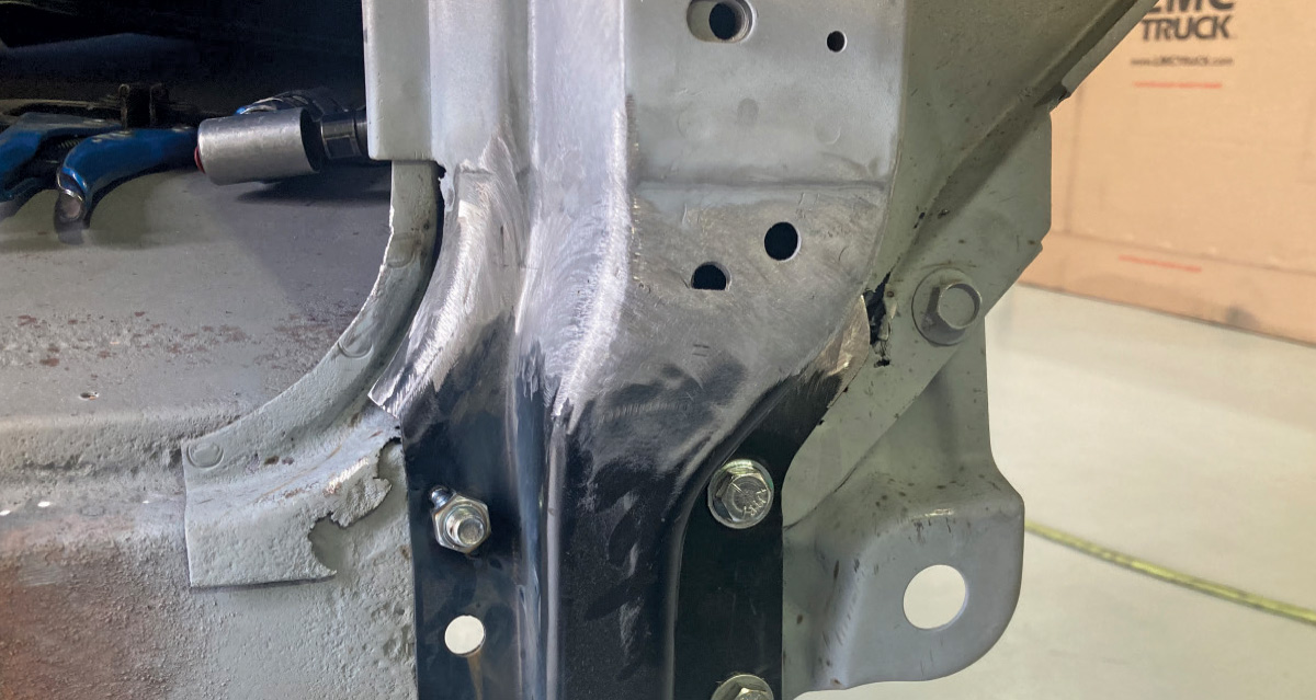 Newly installed A-pillar reinforcement panel secured with bolts
