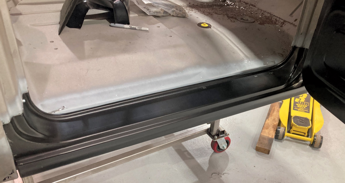 Freshly installed rocker panel and cab corner replacement secured in place