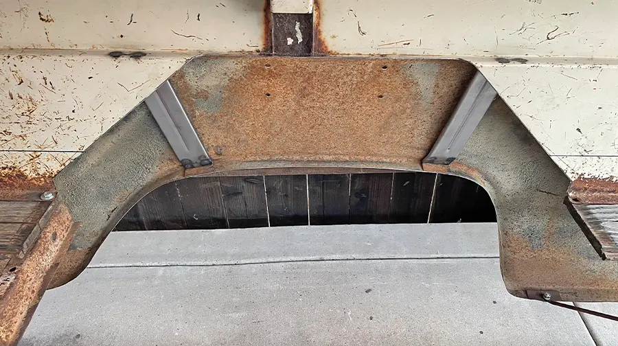 Custom wheel tub cutout in the truck bed with reinforcement plates installed