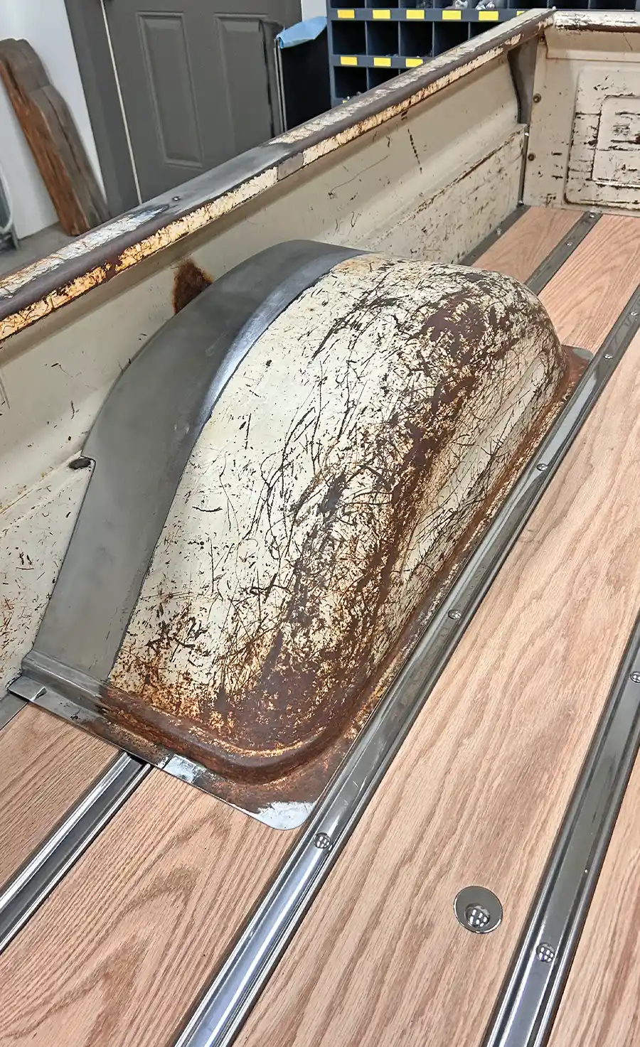 close-up of the original wheel well with patina and new wood bed floor