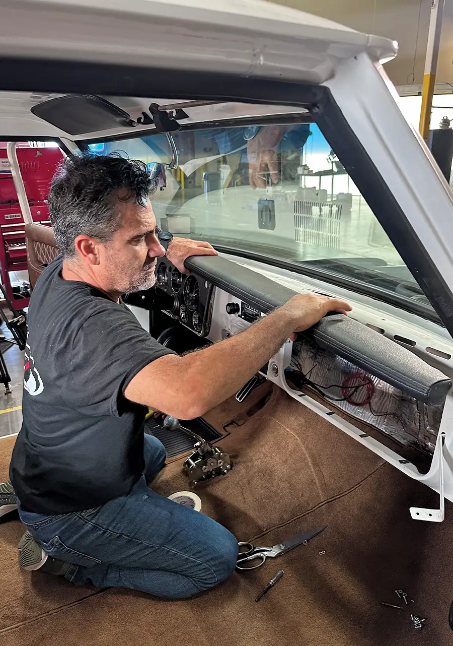 Dashboard being secured in place with leather-wrapped trim