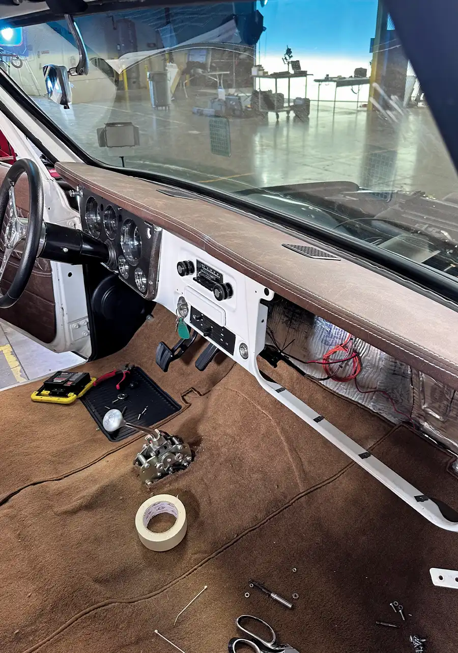 Completed dashboard with brown leather finish and classic chrome gauges