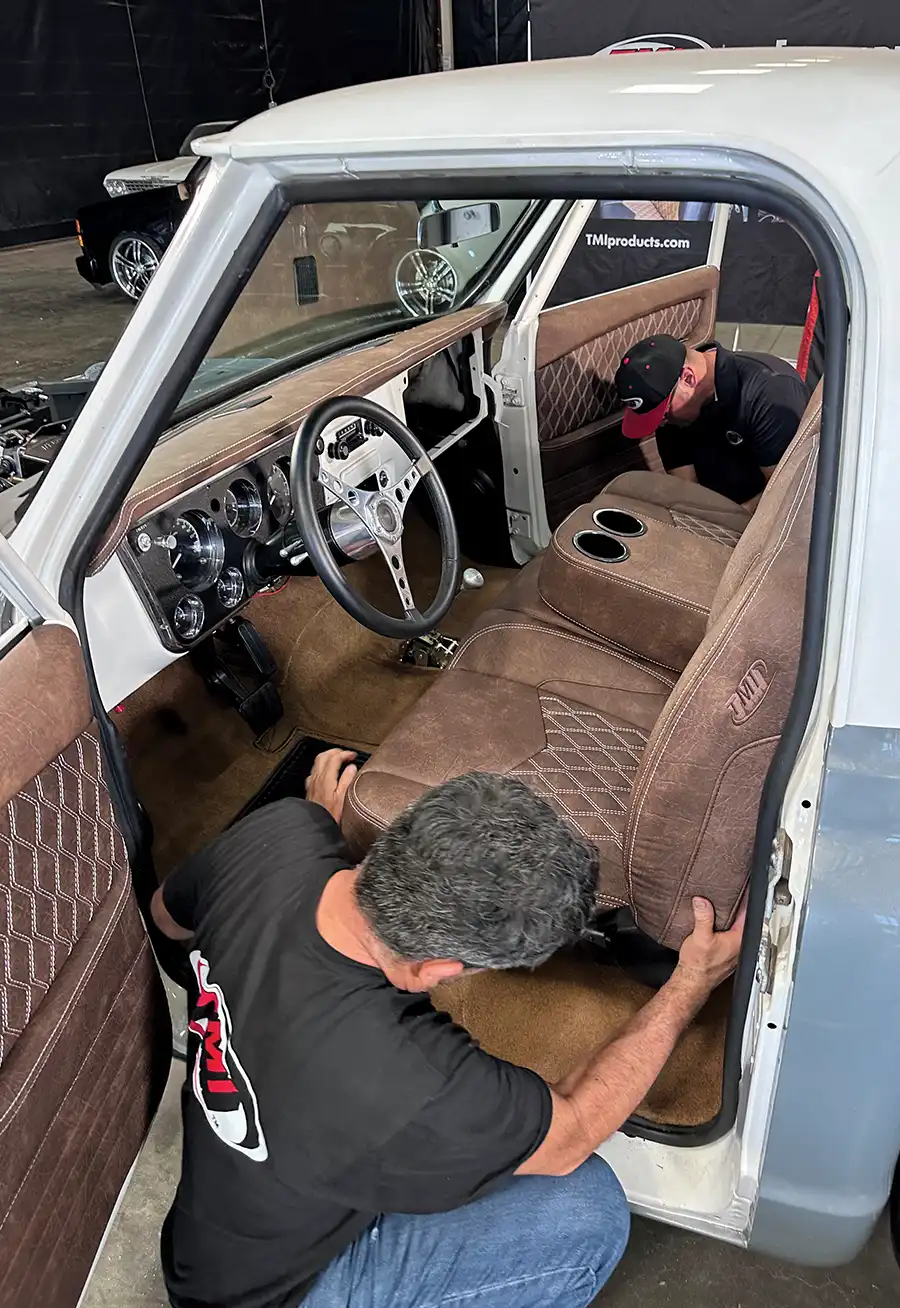 TMI bench seat being installed with diamond-stitched upholstery