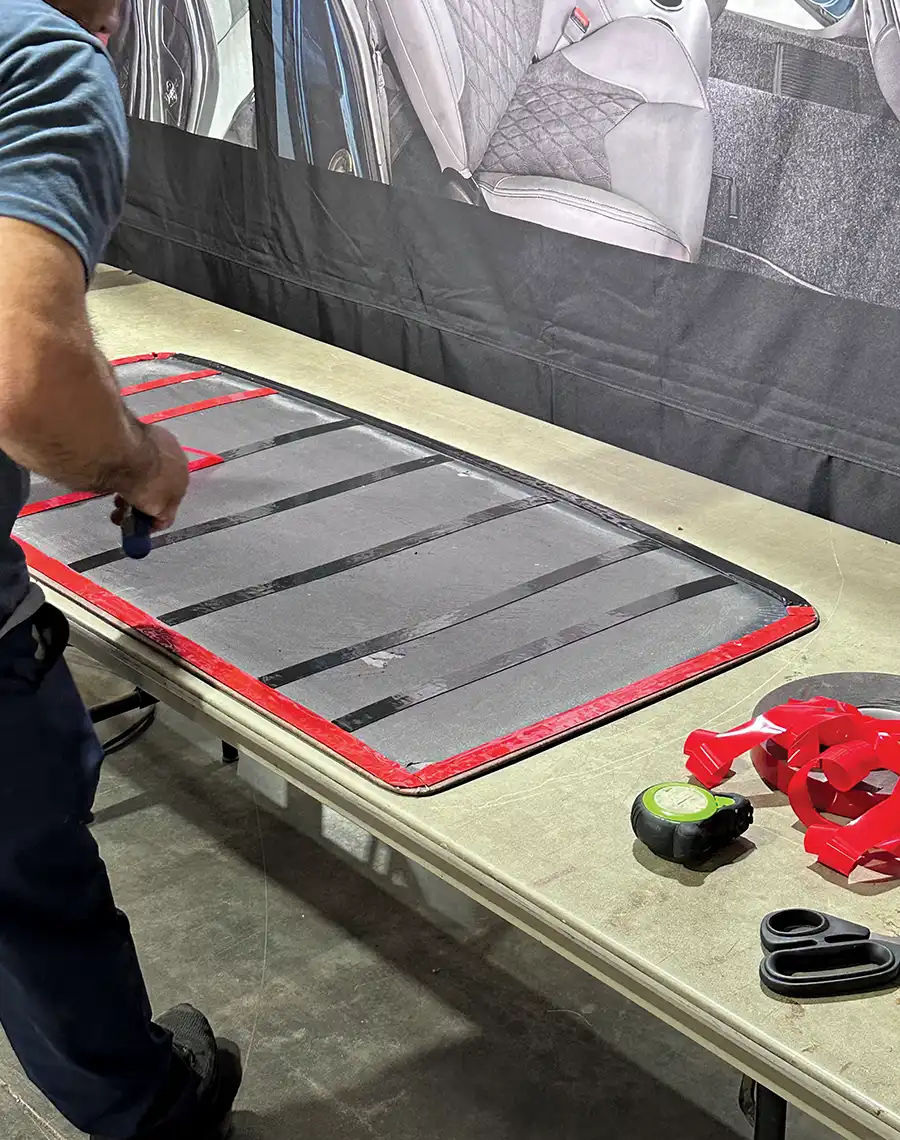 Adhesive strips applied to headliner backing for secure mounting