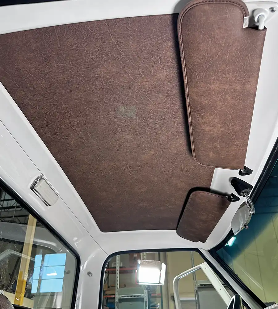 Fully installed headliner and visors complementing brown leather interior