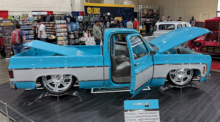 side view of a blue classic truck on display