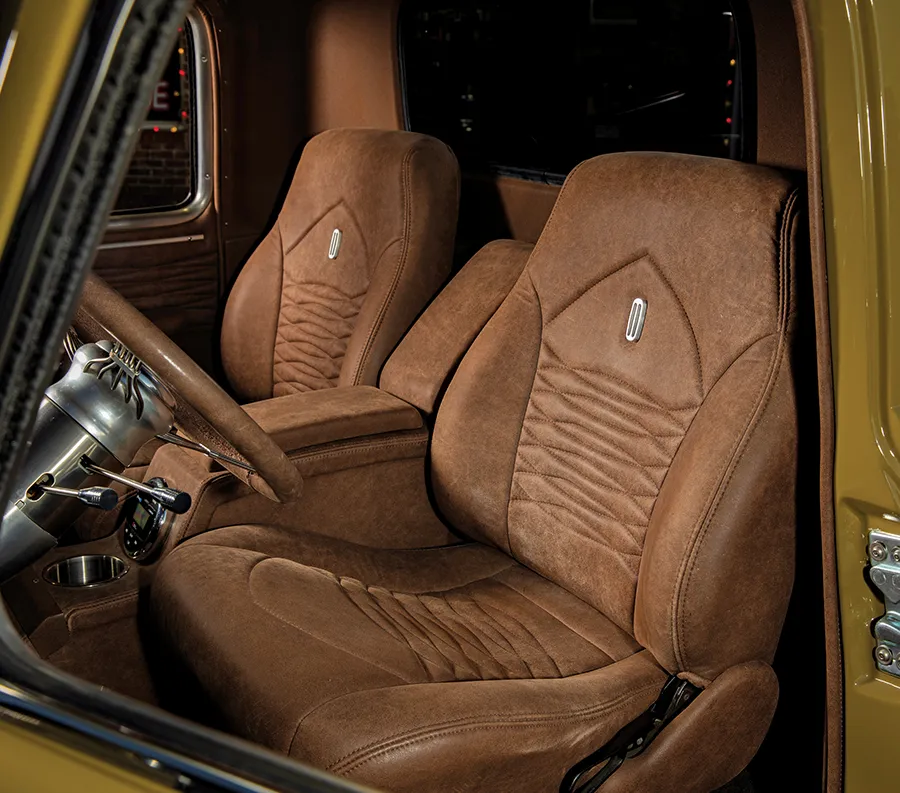 1952 Chevrolet 3100 interior with custom brown leather bucket seats and stitched detailing