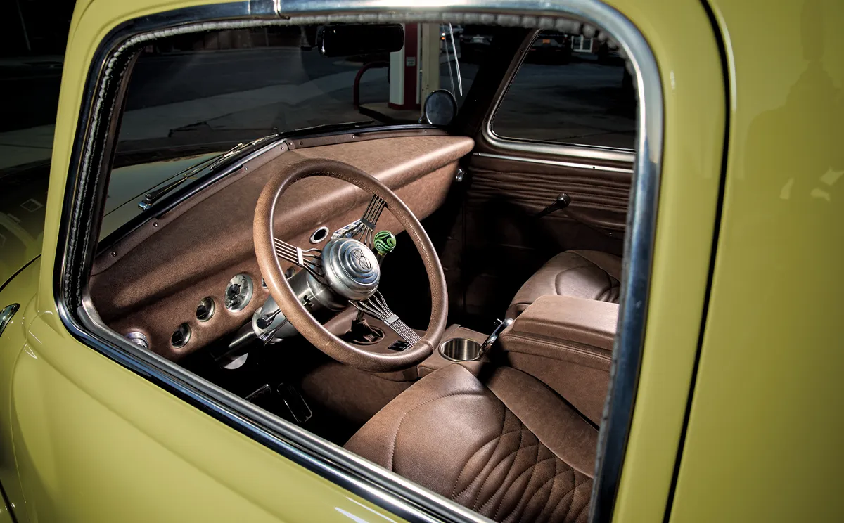 1952 Chevrolet 3100 interior view highlighting a custom brown leather-wrapped steering wheel and classic instrument panel