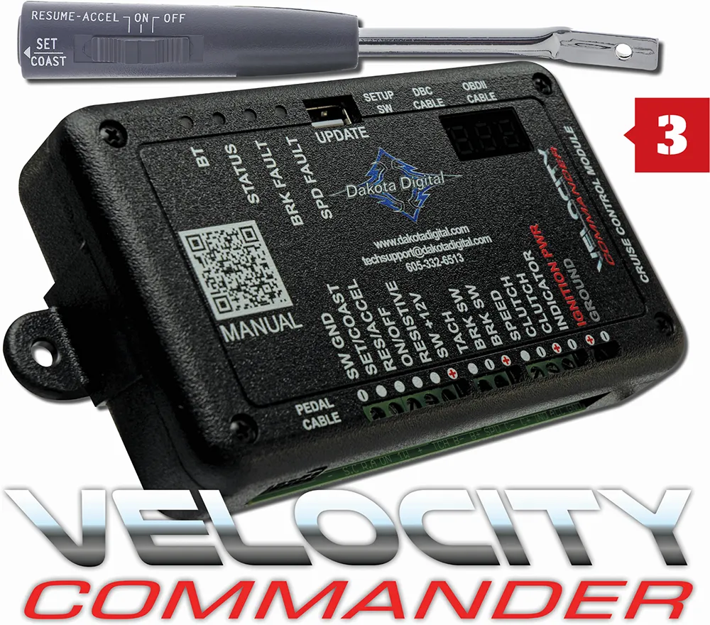 A Dakota Digital electronic device with a QR code and a control lever above it. The text "VELOCITY COMMANDER" is displayed below.